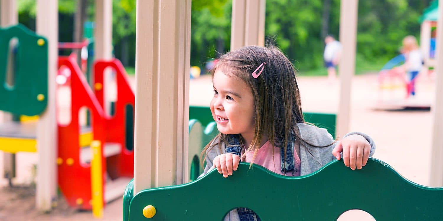 A child smiling on the playground